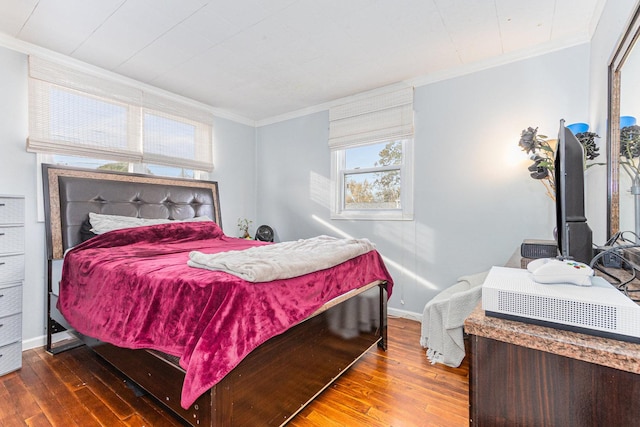 bedroom with hardwood / wood-style flooring and ornamental molding