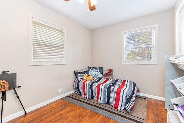 bedroom with hardwood / wood-style floors and ceiling fan