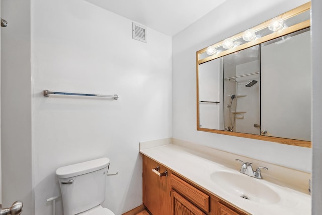 bathroom with walk in shower, vanity, and toilet