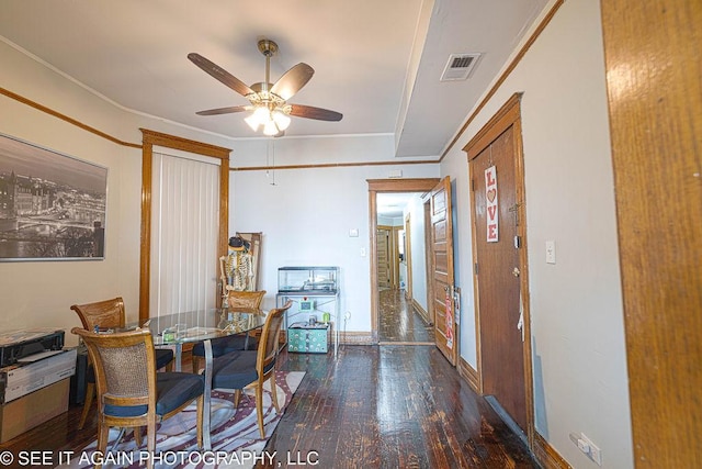 dining space featuring crown molding, visible vents, ceiling fan, wood finished floors, and baseboards