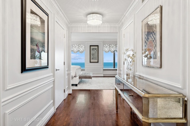 hallway featuring crown molding, a water view, and dark wood-type flooring