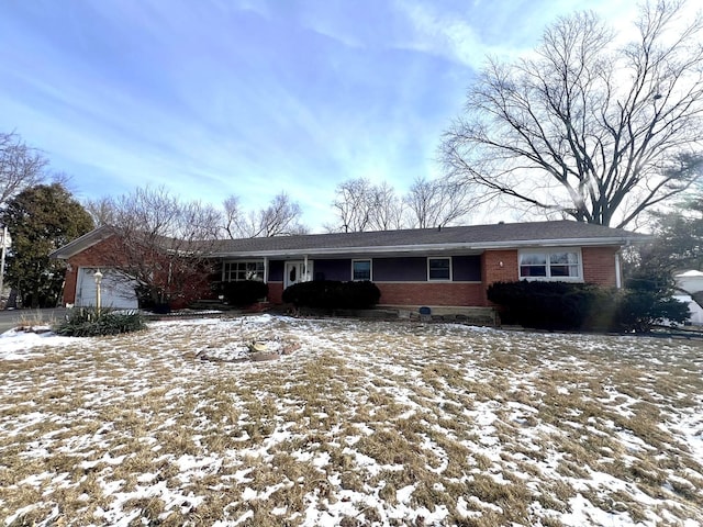 ranch-style house featuring an attached garage and brick siding