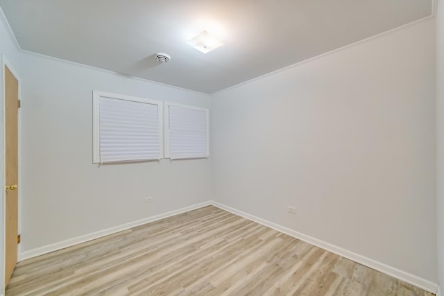 unfurnished room featuring crown molding and light hardwood / wood-style floors