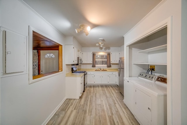 kitchen featuring stainless steel appliances, white cabinetry, ornamental molding, and independent washer and dryer