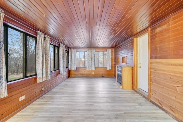 unfurnished sunroom featuring a wealth of natural light and wooden ceiling