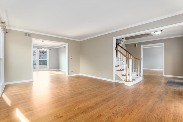 unfurnished room with crown molding, a notable chandelier, and light wood-type flooring