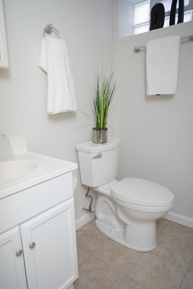 bathroom featuring vanity, tile patterned flooring, and toilet