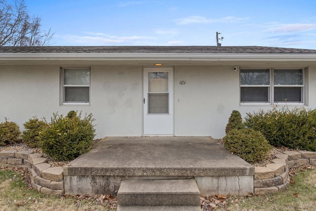 property entrance featuring a patio area