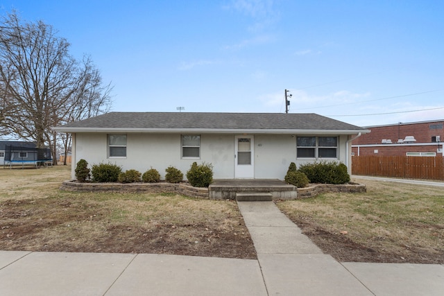 single story home with a trampoline and a front lawn