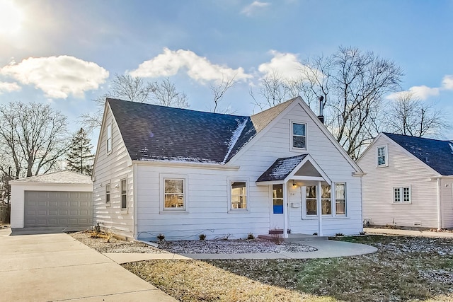 view of front of house featuring a garage and an outbuilding