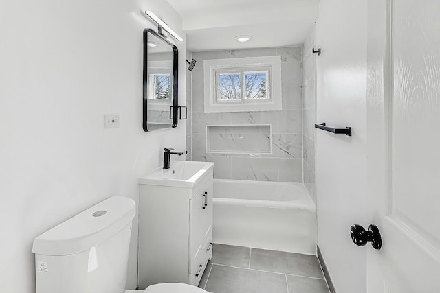 full bathroom with tiled shower / bath combo, vanity, tile patterned floors, and toilet