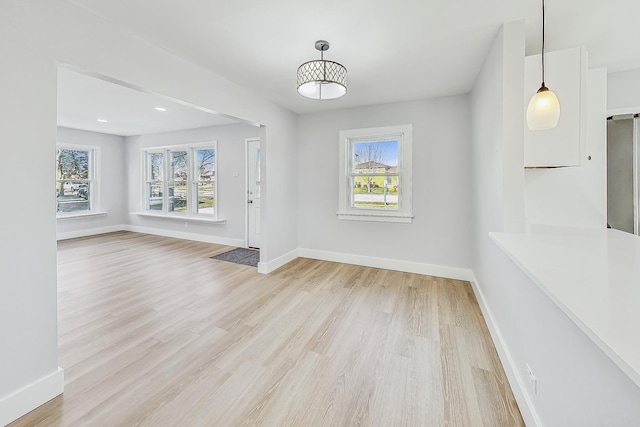 unfurnished dining area featuring light hardwood / wood-style flooring