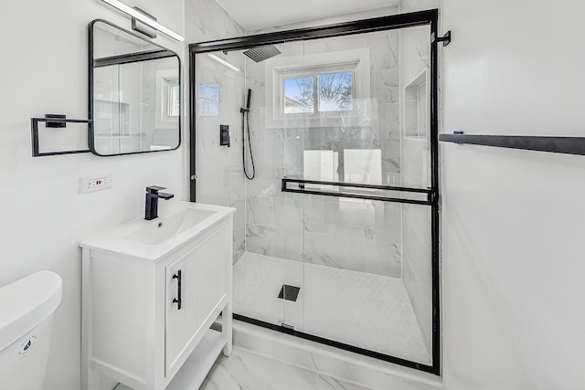 bathroom with vanity, a shower with shower door, and toilet