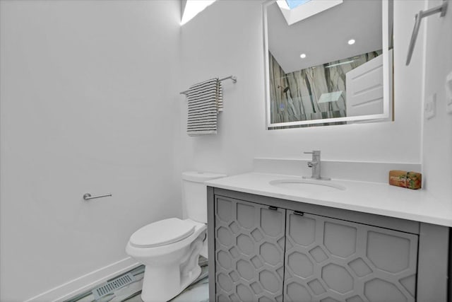 bathroom featuring toilet, a shower with curtain, a skylight, vanity, and a baseboard heating unit