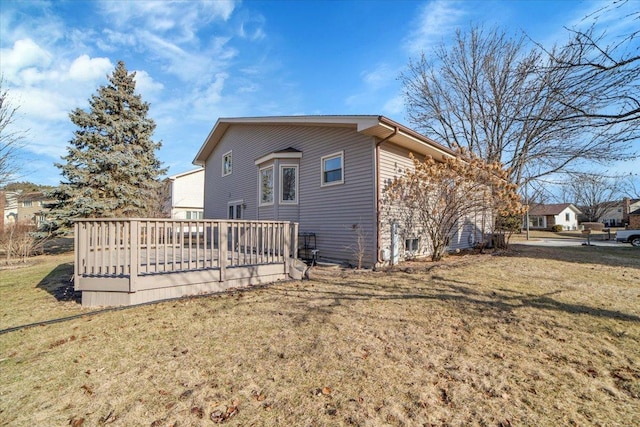 back of house with a yard and a deck