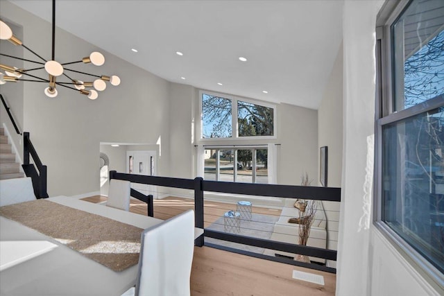 interior space with high vaulted ceiling and a chandelier