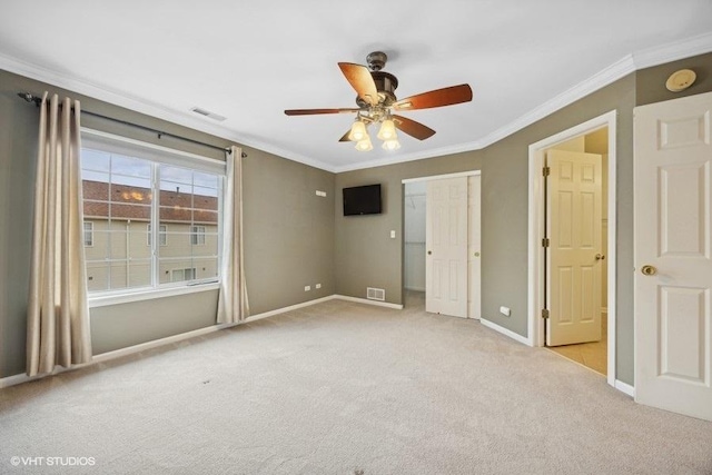 unfurnished bedroom featuring crown molding, light colored carpet, a closet, and ceiling fan