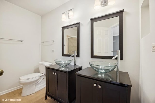 bathroom with tile patterned floors, vanity, and toilet