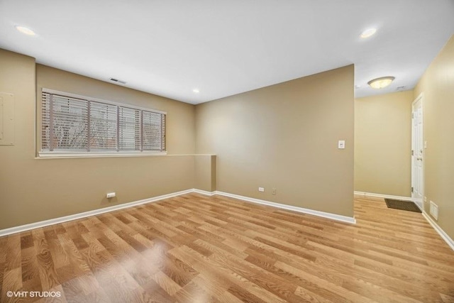 spare room with light hardwood / wood-style flooring