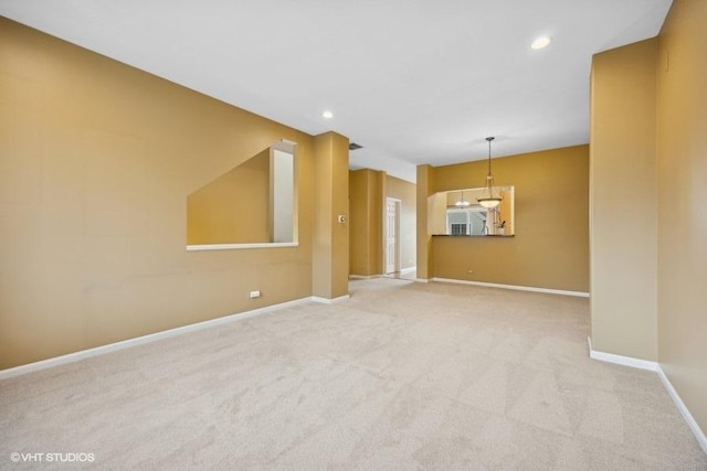 unfurnished living room with light colored carpet