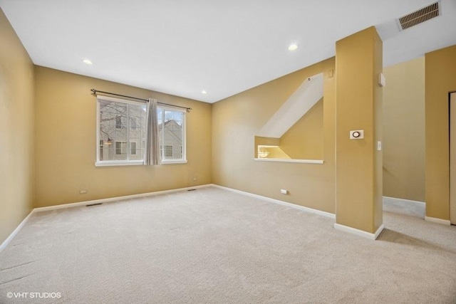 unfurnished room featuring light colored carpet