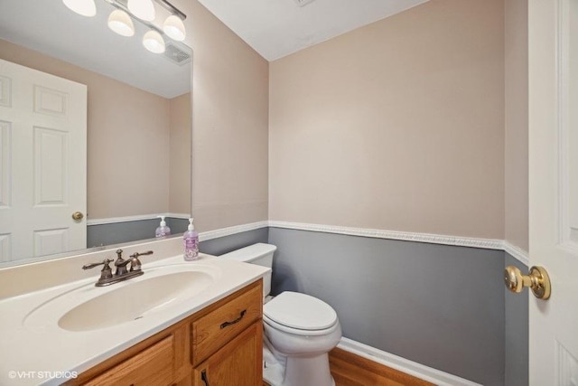 bathroom featuring vanity and toilet