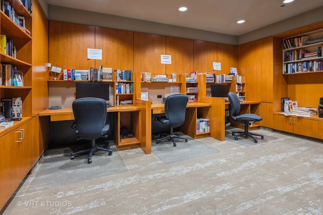 office with built in desk and light hardwood / wood-style floors