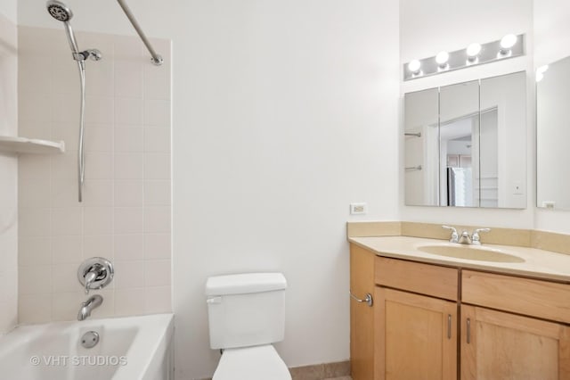 full bathroom featuring tiled shower / bath, vanity, and toilet