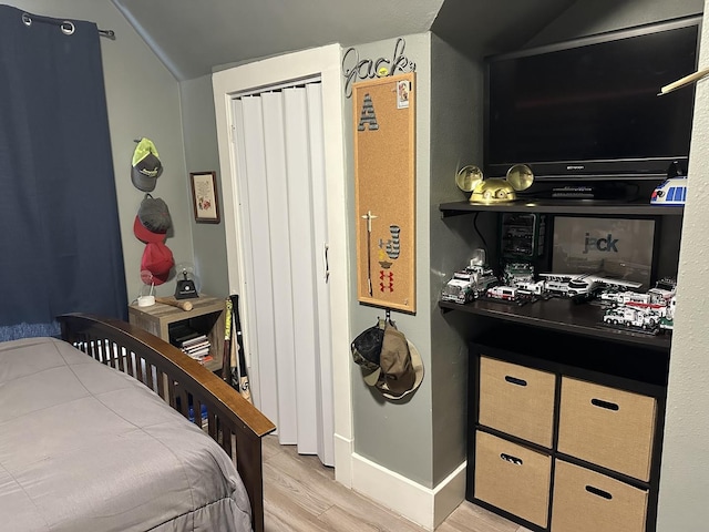 bedroom with a closet and light hardwood / wood-style flooring