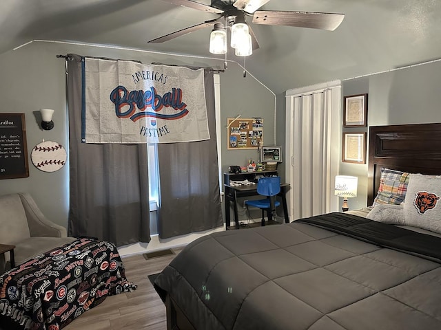 bedroom featuring lofted ceiling, ceiling fan, and light hardwood / wood-style flooring