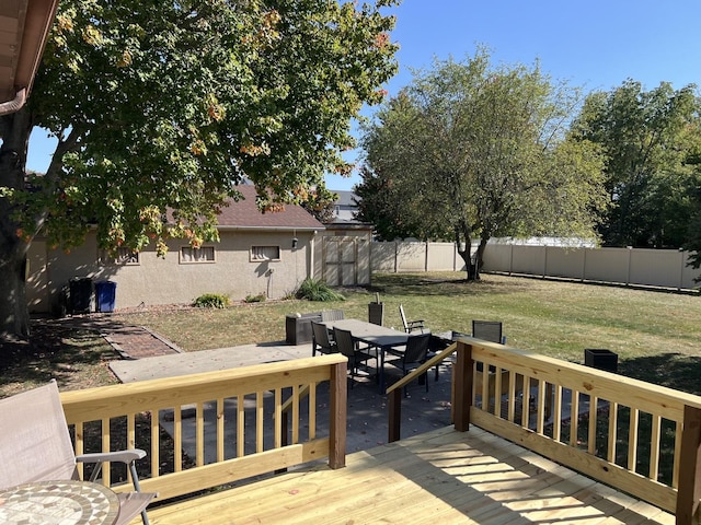 wooden terrace featuring a yard