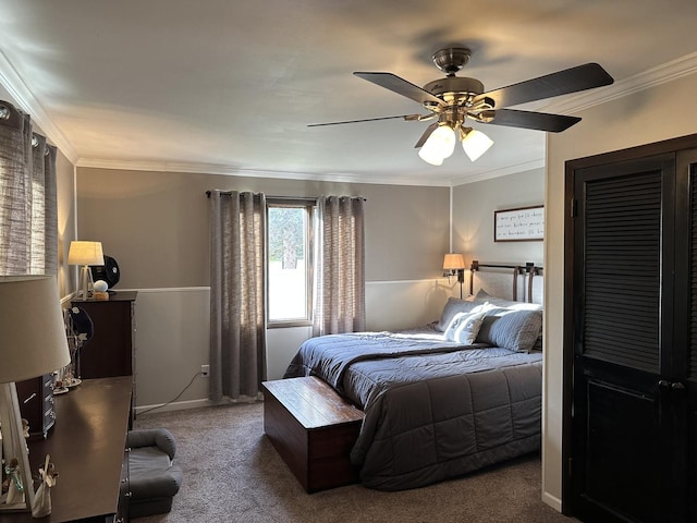 carpeted bedroom featuring crown molding and ceiling fan