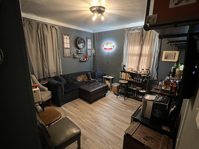 living room featuring ornamental molding and light wood-type flooring