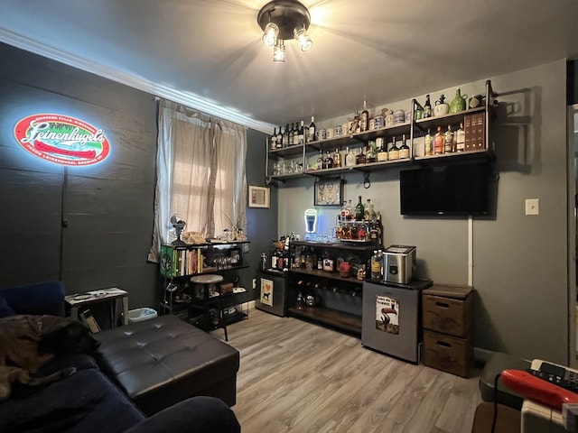 interior space with bar area and light wood-type flooring