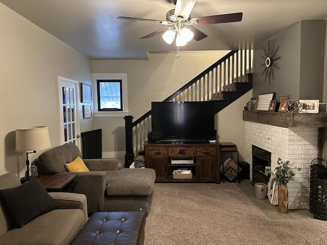 living room featuring a brick fireplace and ceiling fan