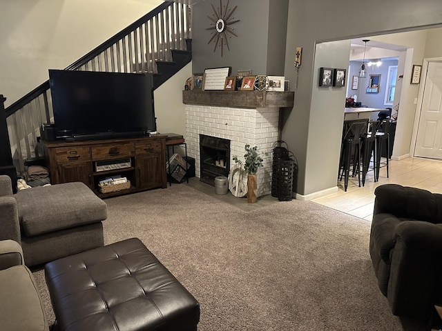 living room featuring light carpet and a brick fireplace