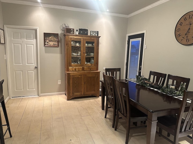 dining room featuring light hardwood / wood-style flooring and ornamental molding