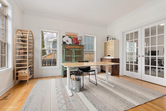 home office featuring hardwood / wood-style flooring, ornamental molding, and french doors