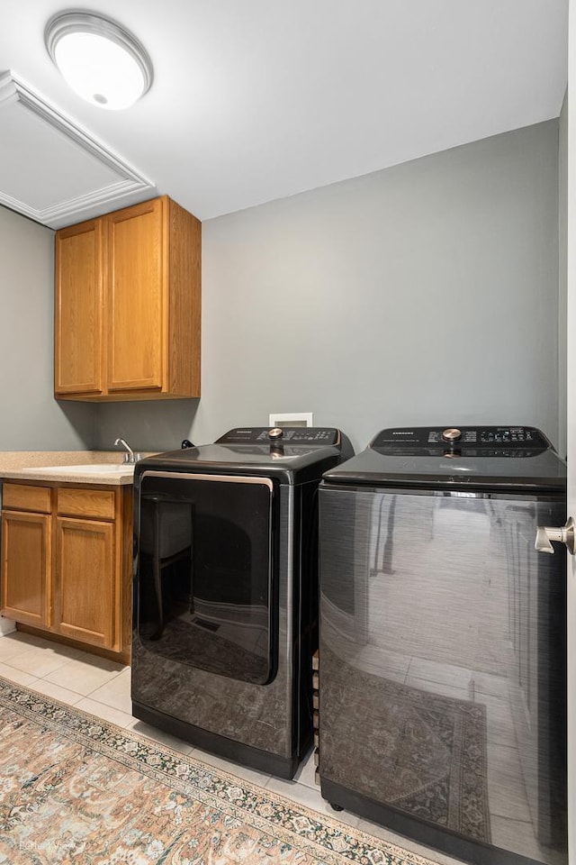 clothes washing area with cabinets, light tile patterned flooring, and separate washer and dryer