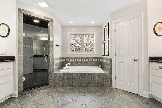 bathroom featuring vanity and separate shower and tub