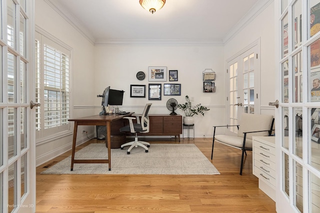 office space featuring crown molding, light hardwood / wood-style floors, and french doors