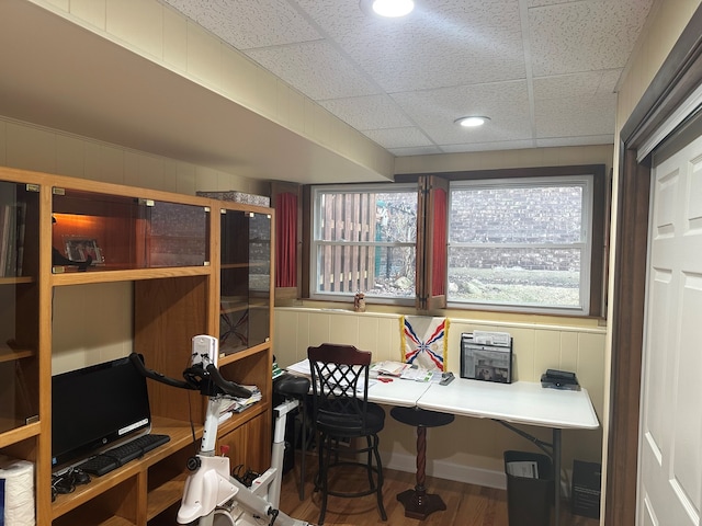 office space featuring hardwood / wood-style flooring and a paneled ceiling