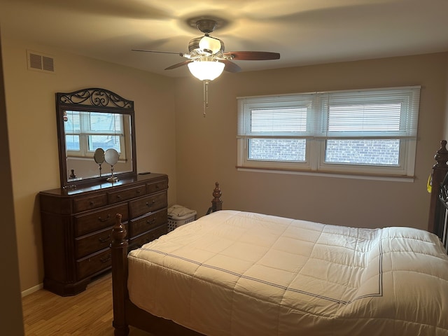 bedroom with ceiling fan and light hardwood / wood-style flooring