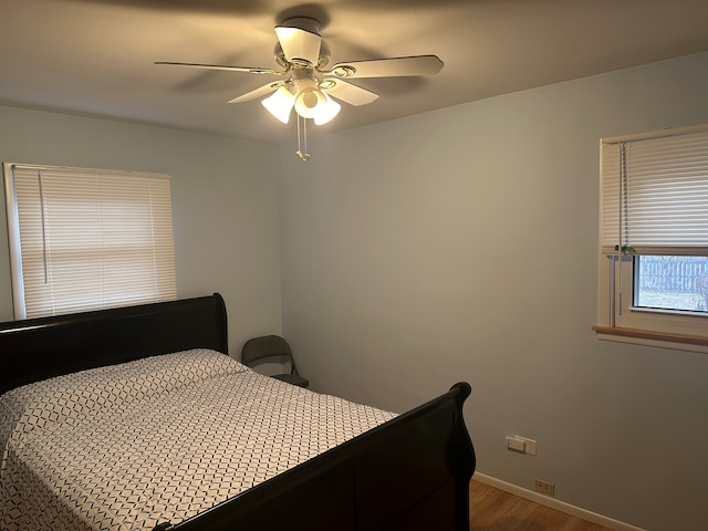 bedroom with hardwood / wood-style flooring and ceiling fan