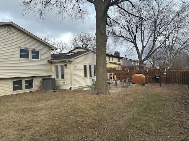 exterior space with a patio, central AC unit, and a lawn