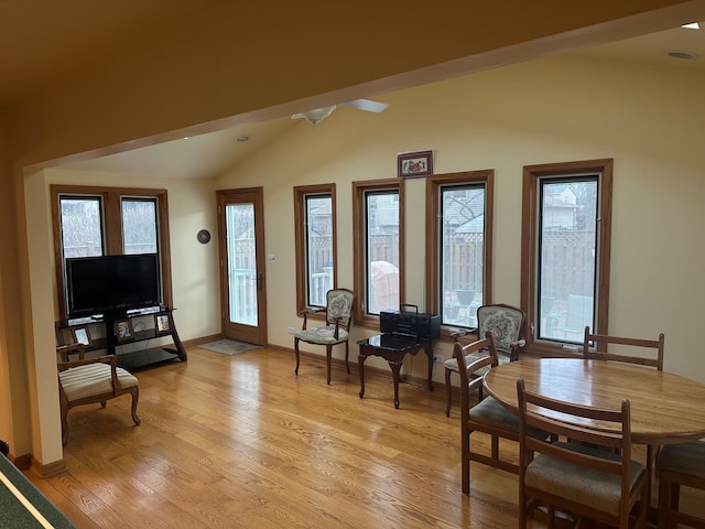 living area with lofted ceiling and light hardwood / wood-style floors