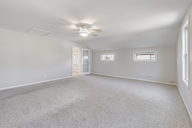 carpeted spare room with vaulted ceiling and ceiling fan