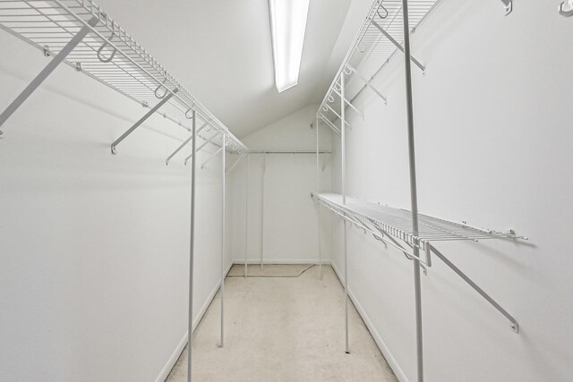 walk in closet featuring vaulted ceiling