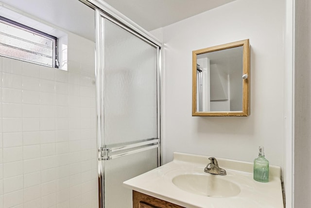 bathroom featuring vanity and an enclosed shower