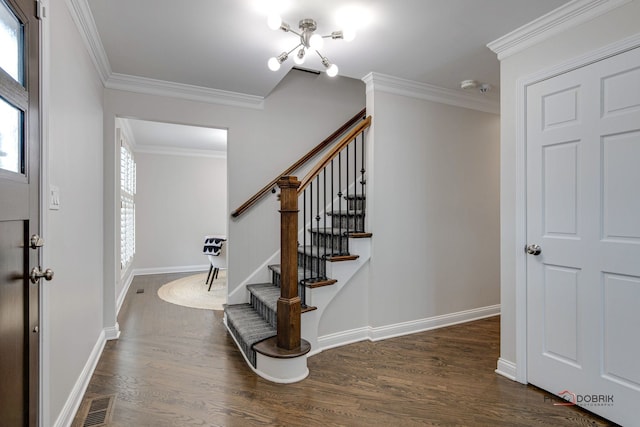 entrance foyer with ornamental molding and dark hardwood / wood-style flooring